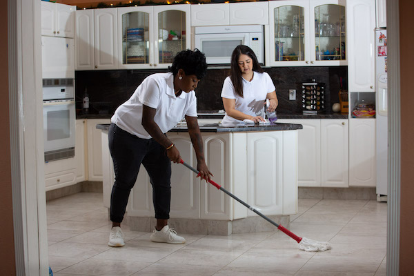 two women cleaning a home
