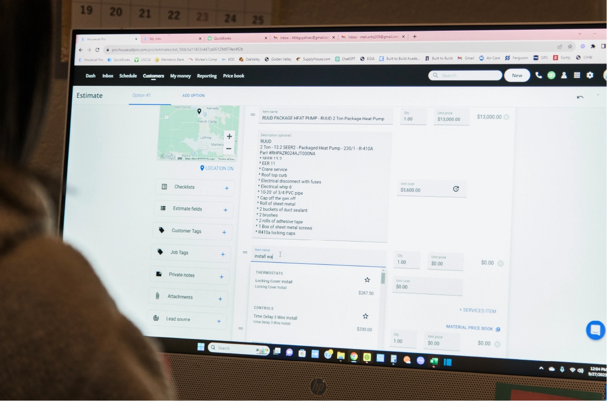 Woman on HP computer monitor using estimating software from Housecall Pro to make service estimate