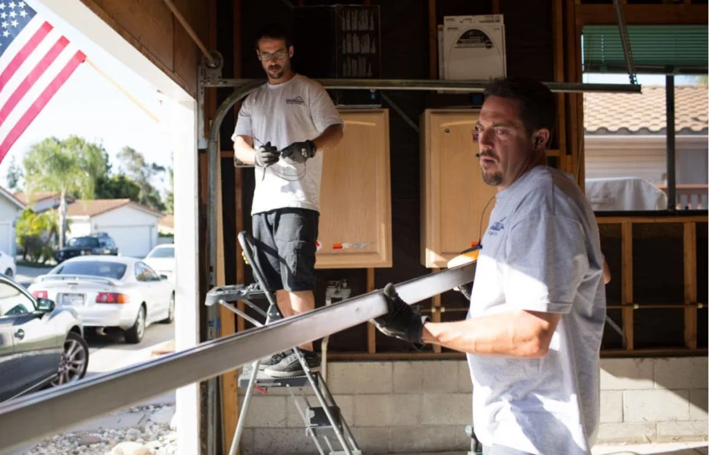 - Housecall Pro Bradbury garage door repair techs fixing garage door frame