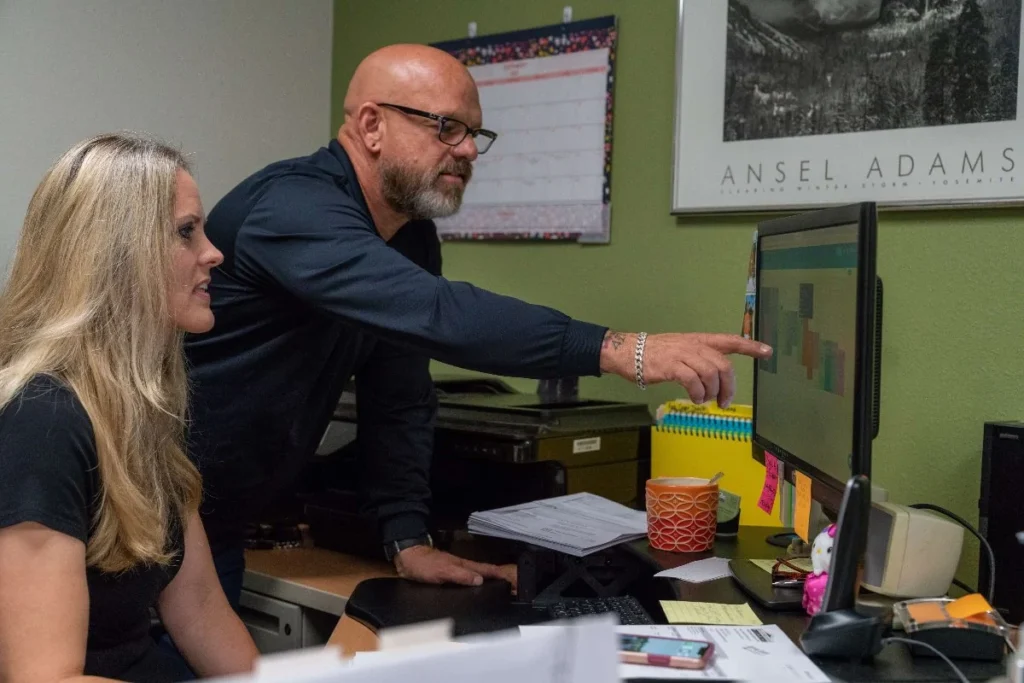 Plumbing businesss management at office computer