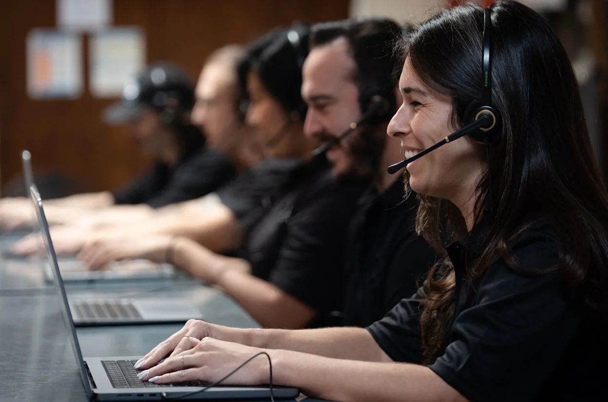 Five reps with headset on their laptop