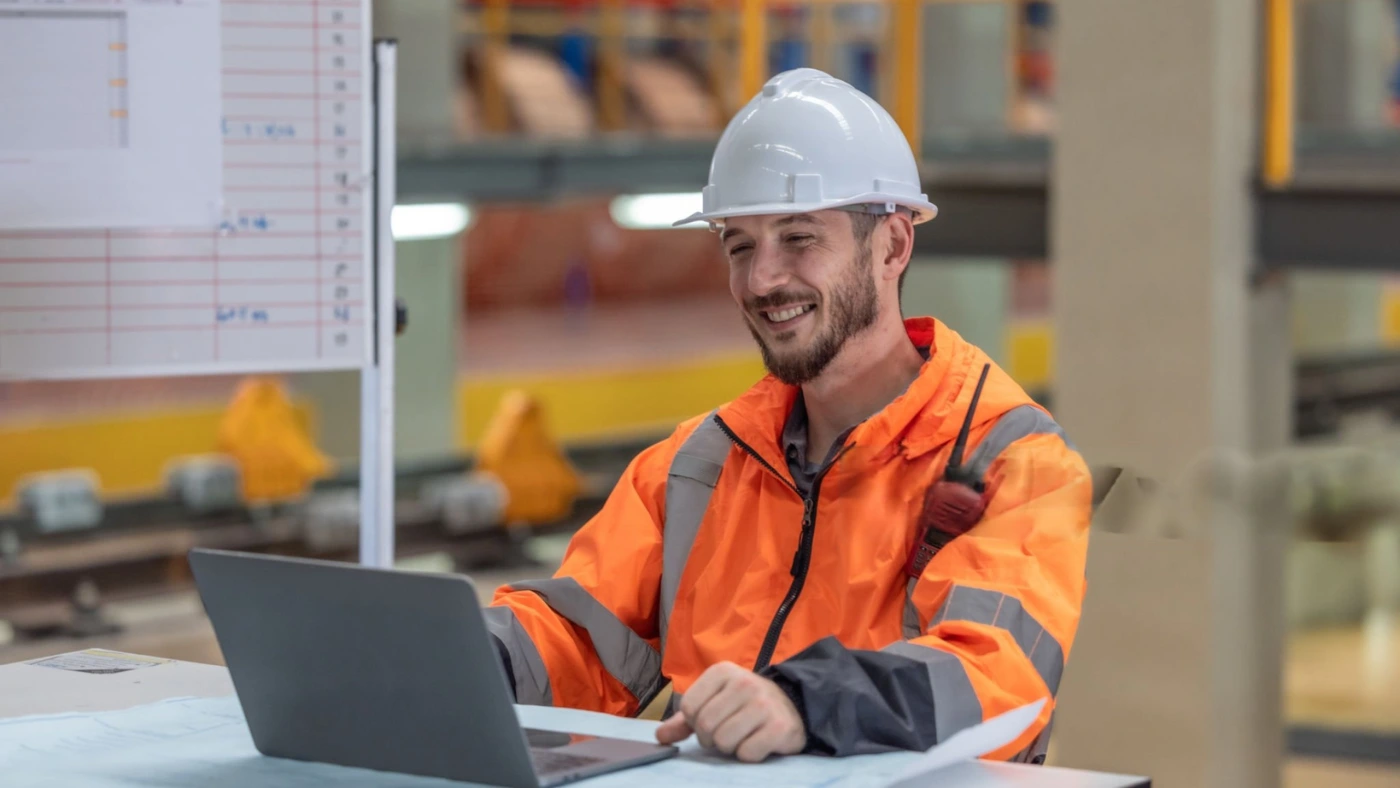 technician sitting on the table and using laptop