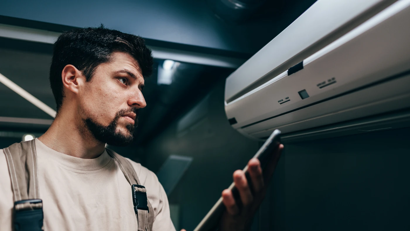 technician reading to check the air conditioner