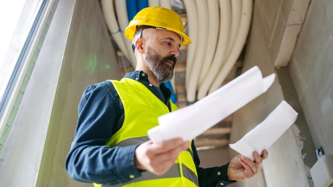 Professional holding papers and examining them.