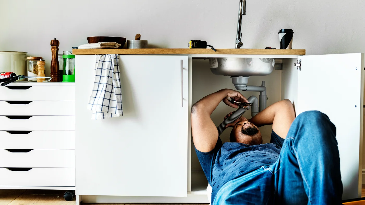 plumber fixing the sink