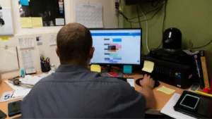 man at computer looking at payroll