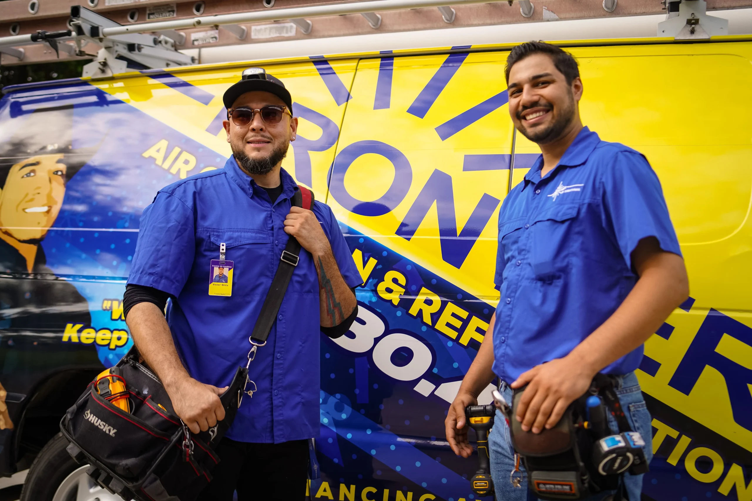 Frontier Air conditioning service techs in front of their work van