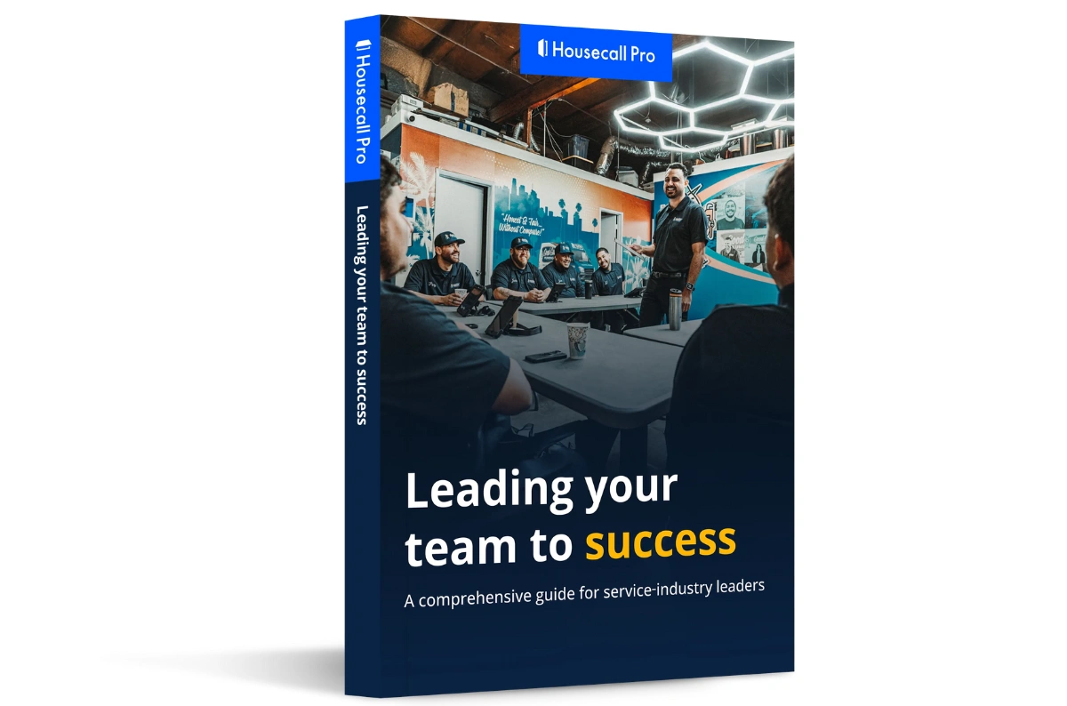 Housecall Pro ebook cover titled 'Leading your team to success' featuring a service-industry leader speaking to a team in a meeting room.