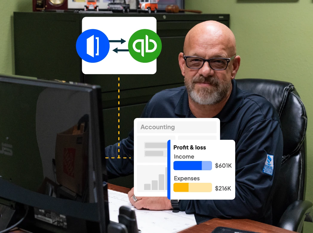 Electrician sits at desk and looks at camera