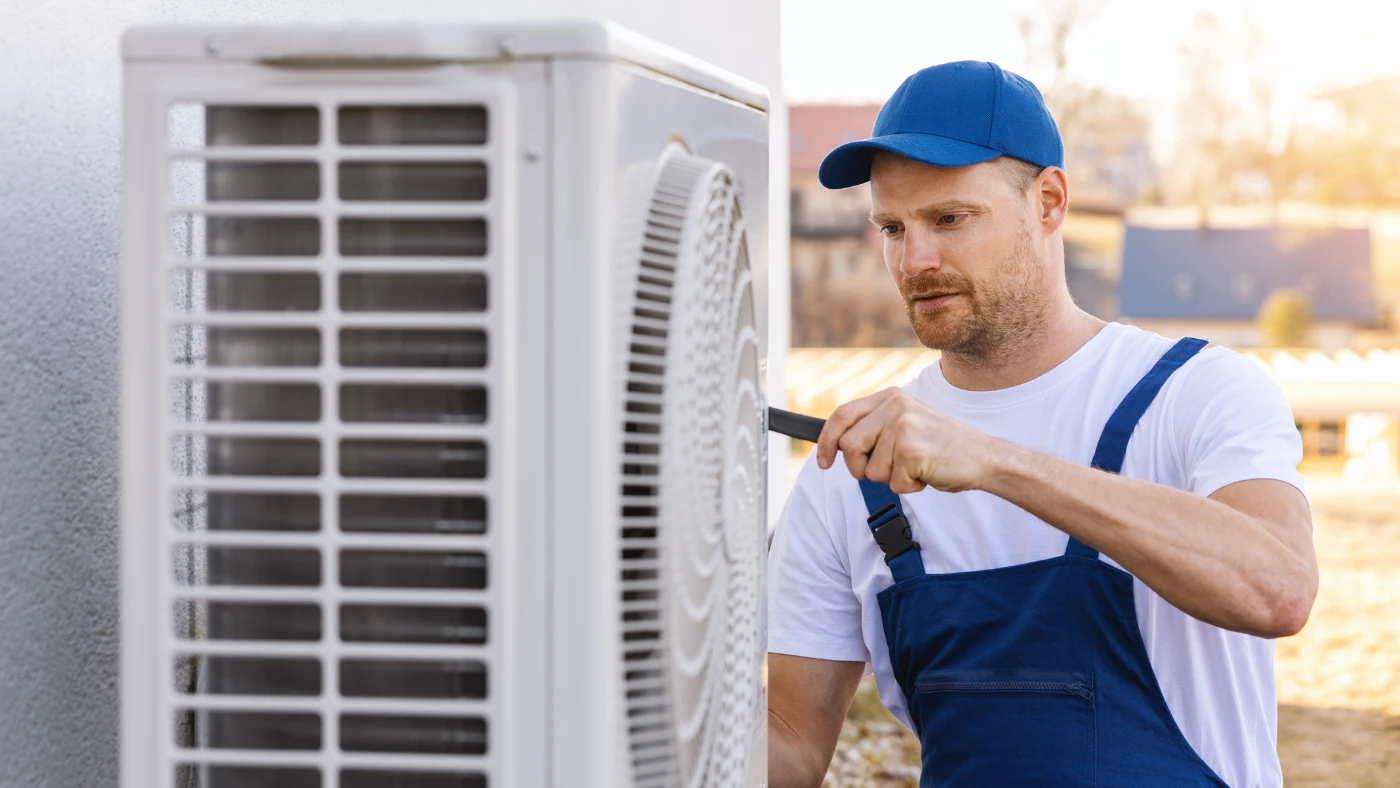 hvac technician is working on air conditioning or heat pump unit
